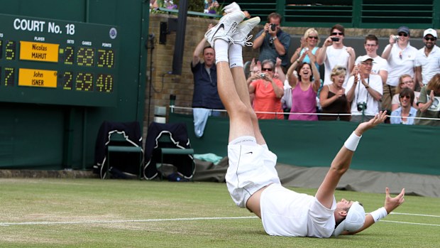 John Isner reacts as he defeats France's Nicolas Mahut, in their men's singles match at Wimbledon. 