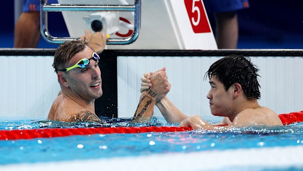 Zhanle Pan of Team People's Republic of China celebrates with Kyle Chalmers of Team Australia after winning gold and silver in the Men's 100m Freestyle Final on day five of the Olympic Games Paris 2024 at Paris La Defense Arena on July 31, 2024 in Nanterre, France. (Photo by Quinn Rooney/Getty Images)
