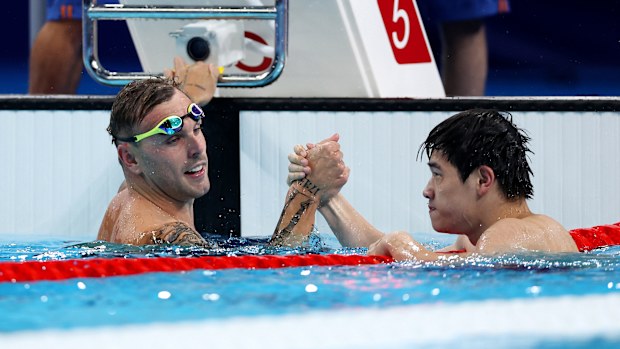 Zhanle Pan of Team People's Republic of China celebrates with Kyle Chalmers of Team Australia after winning gold and silver in the Men's 100m Freestyle Final on day five of the Olympic Games Paris 2024 at Paris La Defense Arena on July 31, 2024 in Nanterre, France. (Photo by Quinn Rooney/Getty Images)