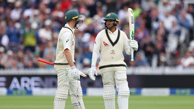 LONDON, ENGLAND - JUNE 30: Usman Khawaja of Australia raises his bat alongside teammate Marnus Labuschagne after scoring a half century during Day Three of the LV= Insurance Ashes 2nd Test match between England and Australia at Lord's Cricket Ground on June 30, 2023 in London, England. (Photo by Ryan Pierse/Getty Images)
