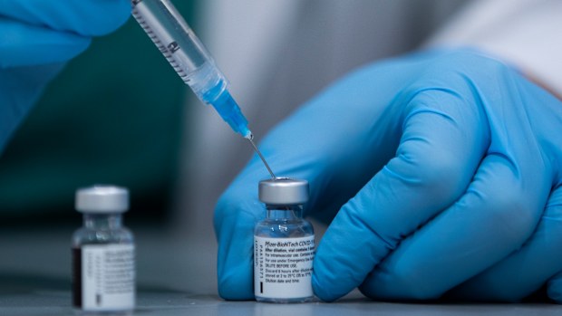 AA health care professional prepares a Pfizer-BioNTech COVID-19 vaccine at Sheba Tel Hashomer Hospital in Ramat Gan, Israel. Israel Defense Minister Benny Gantzs office said Sundya, Jan. 31, 2021, that Israel has agreed to transfer 5,000 doses of the coronavirus vaccine to the Palestinians to immunize front-line medical workers. It is the first time that Israel has confirmed the transfer of vaccines to the Palestinians. (AP Photo/Oded Balilty, File)
