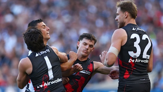 Nick Daicos gets into it with Essendon players.