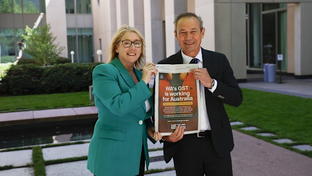 Deputy Premier of Western Australia and Treasurer Rita Saffioti (L) and the Premier of Western Australia Roger Cook (R) pose with a newspaper article at Parliament House on November 05, 2025 in Canberra, Australia.