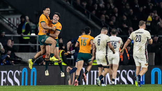 Australia's Len Ikitau and Ben Donaldson celebrate a late try scored by Max Jorgensen.
