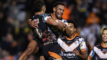 Starford To'a celebrates with Apisai Koroisau after scoring a try during the round 12 NRL match between Wests Tigers and North Queensland Cowboys.