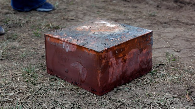 Workers recover a copper box believed to be the 1887 time capsule that was put under the Robert E. Lee pedestal. 