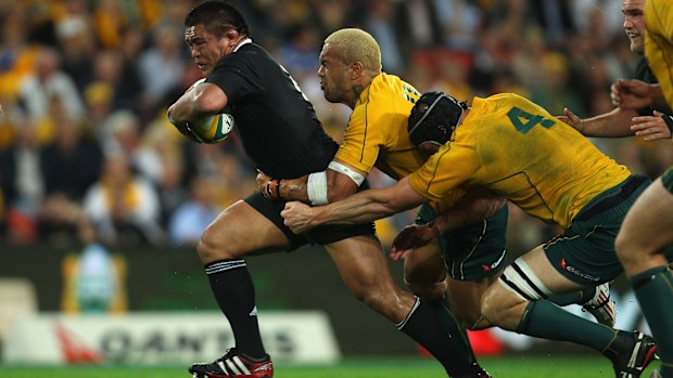 Keven Mealamu of the All Blacks is tackled by Digby Ioane and Dan Vickerman of the Wallabies.