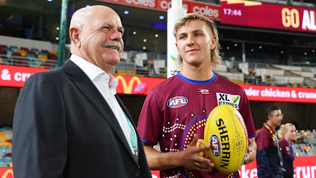 Brisbane's Kai Lohmann of the Lions speaks to Leigh Matthews before his debut.