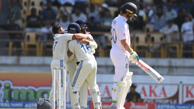 India wicketkeeper Dhruv Jurel and captain Rohit Sharma celebrate with Kuldeep Yadav after Sharma had caught out England batsman Ollie Pope during day four of the 3rd Test Match between India  and England at Saurashtra Cricket Association Stadium on February 18, 2024 in Rajkot, India. (Photo by Gareth Copley/Getty Images)