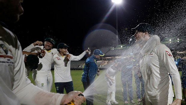 Steve Smith cops a champagne shower in the middle of the ground at Old Trafford.