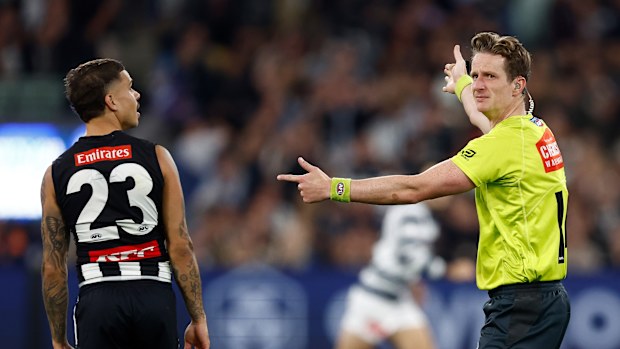 An umpire pays a free kick against Bobby Hill.