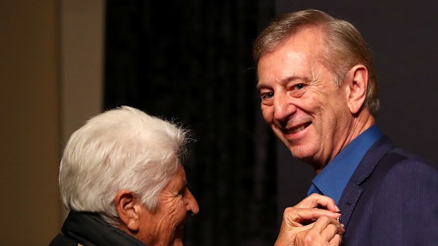 Dennis Cometti is presented an award by Dawn Fraser during the Sport Australia Hall of Fame Induction in 2019.