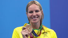 Emily Seebohm beams as she shows off her bronze medal.