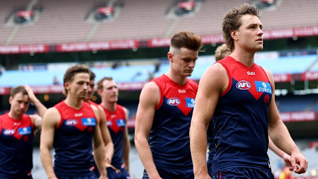 The Demons look dejected after losing the round three AFL match between Melbourne Demons and Gold Coast Suns 