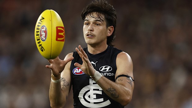 MELBOURNE, AUSTRALIA - MARCH 23: Zac Fisher of the Blues marks the ball during the round two AFL match between Carlton Blues and Geelong Cats at Melbourne Cricket Ground, on March 23, 2023, in Melbourne, Australia. (Photo by Daniel Pockett/Getty Images)