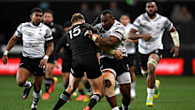 Peni Ravai of Fiji runs into the All Blacks defence in Dunedin.