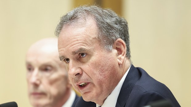 Paul O'Sullivan, former Chairman, and John Arthur, Chairman, from Optus,  during the Triple Zero service outage hearing with the Senate Environment and Communications References Committee, at Parliament House in Canberra on Monday 3 November 2025.