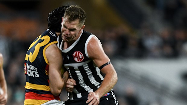 Izak Rankine of the Crows is knocked out by a late hit from Dan Houston in 2024.