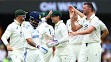 BRISBANE, AUSTRALIA - DECEMBER 16: Josh Hazlewood of Australia celebrates with teammates after dismissing Virat Kohli of India during day three of the Third Test match in the series between Australia and India at The Gabba on December 16, 2024 in Brisbane, Australia. (Photo by Chris Hyde/Getty Images)