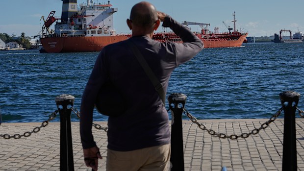 A person watches the oil tanker Ocean Mariner, Monrovia, arrive to the bay in Havana, Cuba, Friday, Jan. 9, 2026. 