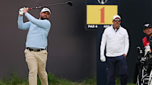 Peake on the first tee as playing partner Phil Mickelson watches on.