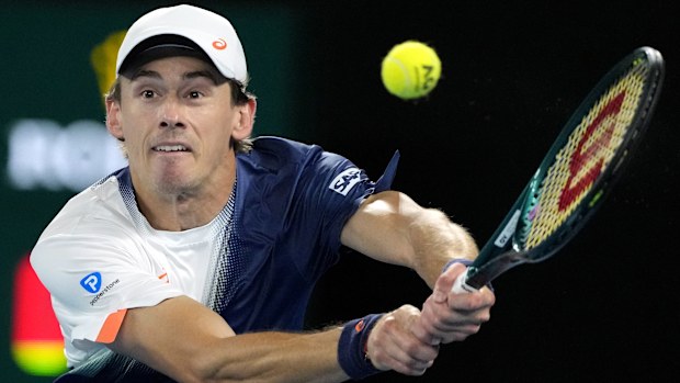 Alex de Minaur of Australia plays a backhand return to Jannik Sinner of Italy during their quarterfinal match at the Australian Open tennis championship in Melbourne, Australia, Wednesday, Jan. 22, 2025. (AP Photo/Vincent Thian)