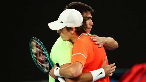 Alex de Minaur embraces Carlos Alcaraz of Spain following a charity match ahead of the 2024 Australian Open.