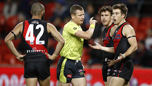 Zach Merrett of the Bombers questions the umpire.