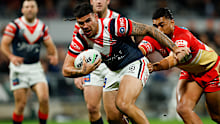 Terrell May of the Roosters attempts to break through.