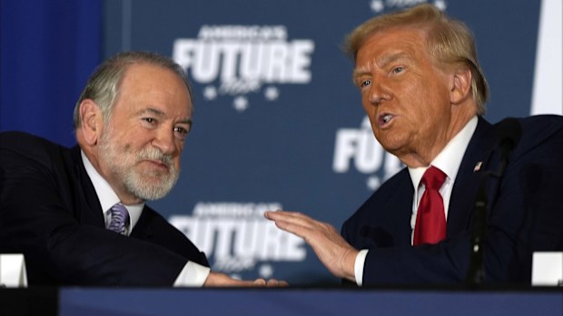 Republican presidential nominee former President Donald Trump talks with former Arkansas Gov. Mike Huckabee during a roundtable at the Drexelbrook Catering & Event Center, Tuesday, Oct. 29, 2024, in Drexel Hill, Pa. (AP Photo/Julia Demaree Nikhinson)