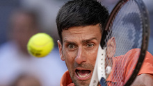 Novak Djokovic returns the ball to Carlos Alcaraz during a mens semifinal at the Mutua Madrid Open tennis tournament in Madrid, Spain.
