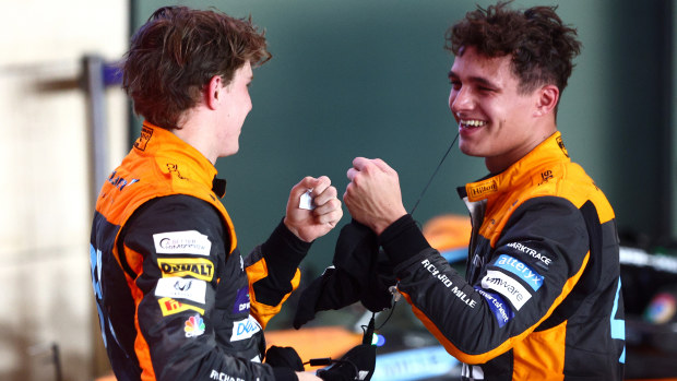 Lando Norris (right) and Oscar Piastri bump fists after finishing second and third respectively in the Qatar Grand Prix.