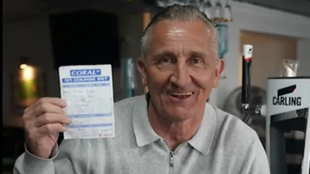 Tim Piper holds aloft the bet slip that won him $100,000.