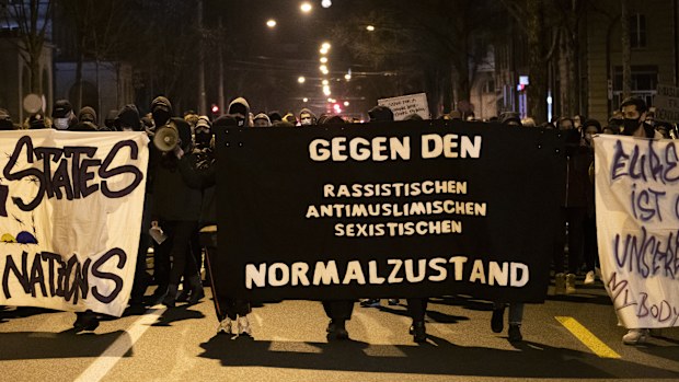 Demonstrators hold sign reading "against racist anti-muslim, sexist, normalisation" during a protest after the Burqa ban referendum was narrowly approved in Switzerland.