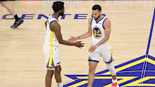 Golden State's Andrew Wiggins high fives teammate Stephen Curry.