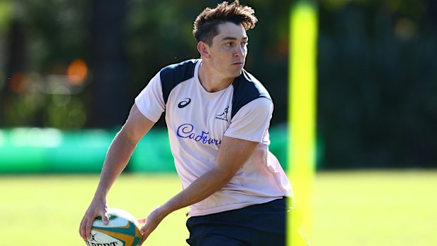 Jock Campbell passes during a Wallabies training session at Royal Pines Resort.