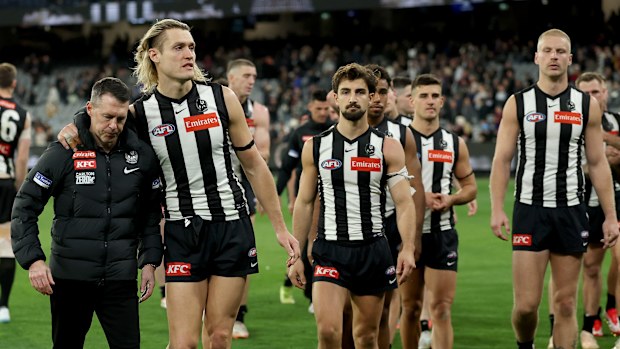 Craig McRae, Senior Coach of the Magpies and Darcy Moore of the Magpies look dejected after losing the AFL Preliminary Final