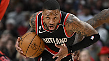 PORTLAND, OREGON - FEBRUARY 26: Damian Lillard #0 of the Portland Trail Blazers drives to the basket against Tari Eason #17 and Alperen Sengun #28 of the Houston Rockets during the first quarter at the Moda Center on February 26, 2023 in Portland, Oregon. NOTE TO USER: User expressly acknowledges and agrees that, by downloading and or using this photograph, User is consenting to the terms and conditions of the Getty Images License Agreement. (Photo by Alika Jenner/Getty Images)