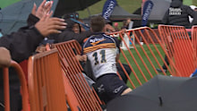 Corey Toole crashes into the fence after his try. 