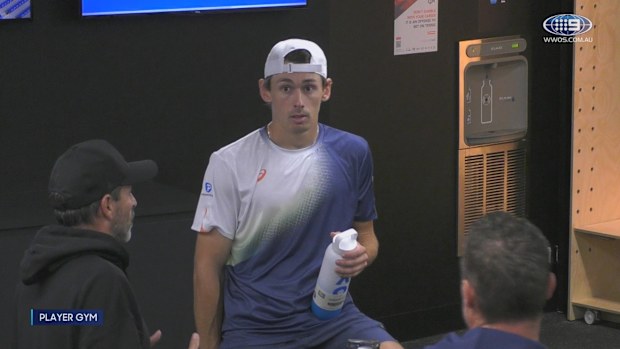 Alex de Minaur in conversation with Lleyton Hewitt and Adolfo Gutierrez after his loss to Jannik Sinner.