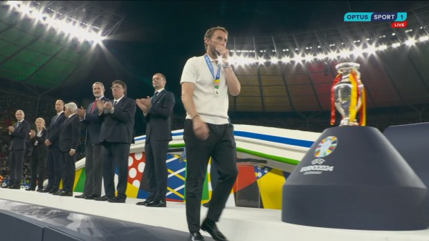 Gareth Southgate walks past Euro trophy.