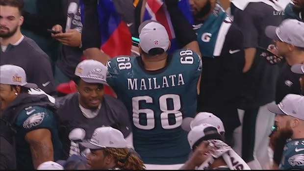 Jordan Mailata celebrates his Philadelphia Eagles' victory in the Super Bowl with an Australian and Samoan flag.