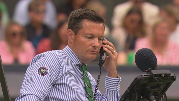 Chair umpire Nico Helwerth makes a call to clarify an error with the line-calling system. 