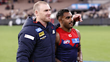 Simon Goodwin, Senior Coach of the Demons embraces Kysaiah Pickett.