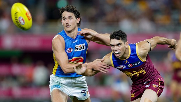 Wil Powell of the Suns and Charlie Cameron of the Lions in action during the 2024 AFL Round 08 match between the Brisbane Lions and the Gold Coast SUNS at The Gabba on May 05, 2024 in Brisbane, Australia. (Photo by Russell Freeman/AFL Photos via Getty Images)
