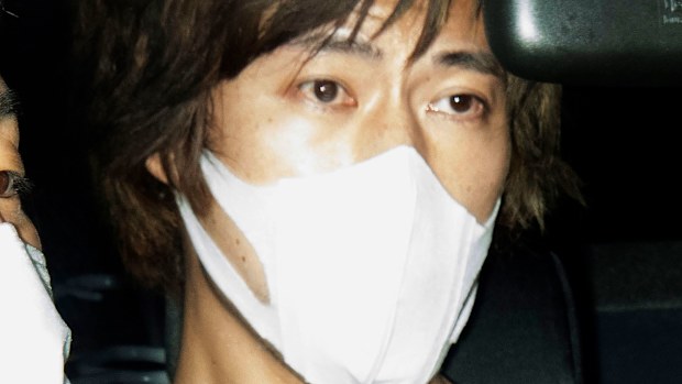 A vehicle carrying Yusuke Tsushima arrives at a police station in Tokyo Saturday morning, Aug. 7, 2021. 