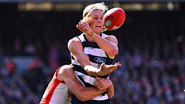Sam De Koning of the Cats handpasses the ball in a tackle during the 2022 Toyota AFL Grand Final match between the Geelong Cats and the Sydney Swans at the Melbourne Cricket Ground on September 24, 2022 in Melbourne, Australia. (Photo by Daniel Carson/AFL Photos)