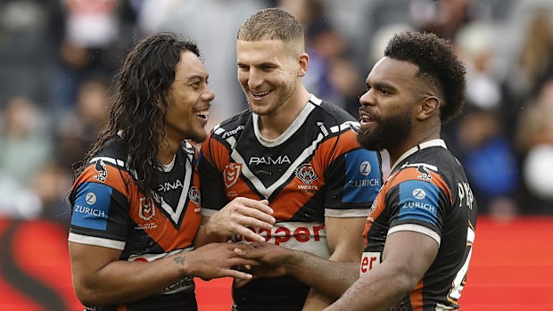 SYDNEY, AUSTRALIA - AUGUST 03: Jarome Luai, Adam Doueihi and Sunia Turuva of the Wests Tigers celebrate victory during the round 22 NRL match between Wests Tigers and Canterbury Bulldogs at CommBank Stadium, on August 03, 2025, in Sydney, Australia. (Photo by Mark Evans/Getty Images)