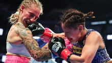 Miyo Yoshida of Japan punches Ebanie Bridges of Australia during their IBF bantamweight title fight at Chase Center.