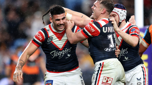 Terrell May of the Roosters celebrates with teammates after scoring a try.